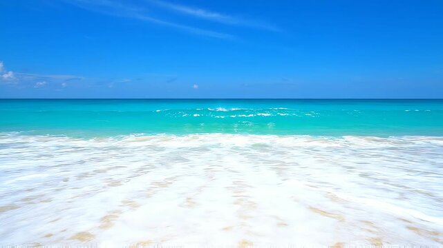 Ocean Serenity: A breathtaking panorama of a pristine beach with turquoise water gently lapping at the shore under a clear blue sky, inviting a sense of peace and escape.