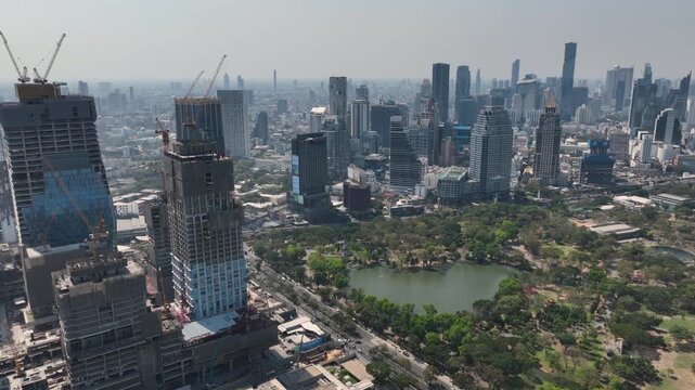 sunny day bangkok city downtown central park modern office complex construction aerial panorama 4k thailand 