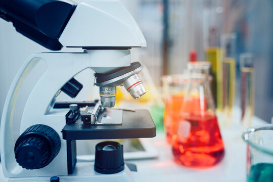 Laboratory research, microscope with lab glassware, science laboratory research and development concept.