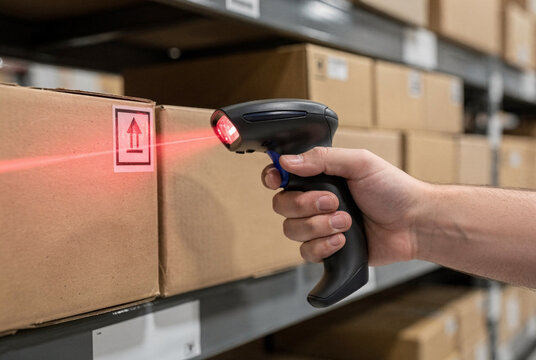 Warehouse Worker Scanning Cardboard Box with Barcode Reader