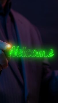 Close-up vertical shot of hand writing glowing neon Welcome text script. Dark neon light background, digital hospitality welcome and service engagement concept.