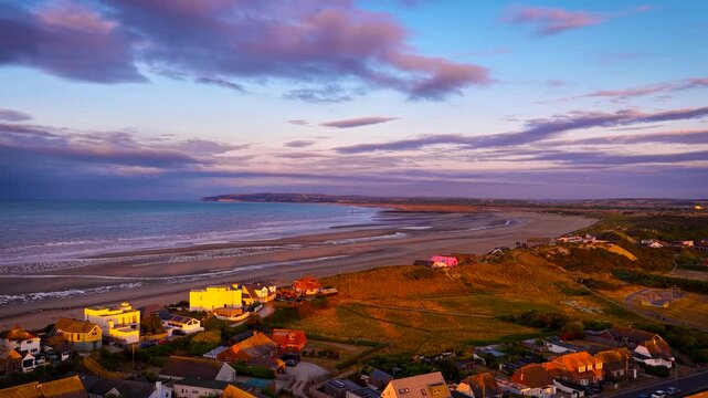Aerial view of Camber Sands after sunrise, with shoreline, tidal sand patterns and blue sea in East Sussex; ideal for travel, tourism and coastal advertising