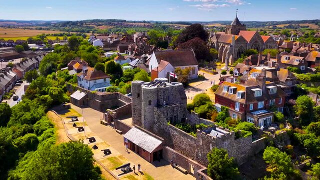 View of Rye cathedral and Ypres Tower rising above historic rooftops in East Sussex, England, in bright daylight; ideal for travel, heritage and tourism marketing