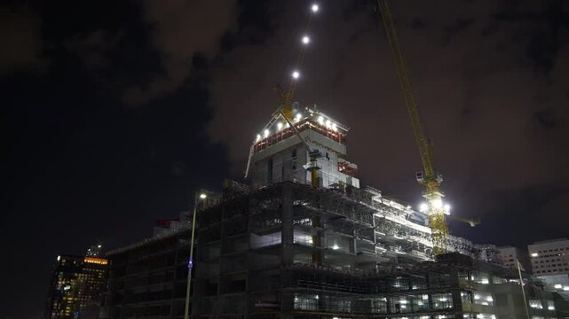 night time illuminated abu dhabi new modern construction top cranes panorama 4k united arab emirates