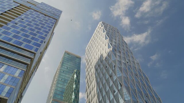 sunny day time abu dhabi city downtown modern office buildings exterior up view slow motion panorama 4k united arab emirates