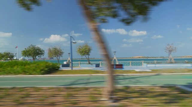 sunny day abu dhabi city famous traffic bay road trip passenger side pov slow motion panorama 4k united arab emirates