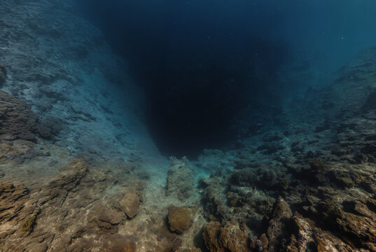 Generated fictional underwater scene with seabed and a large abyss pit.