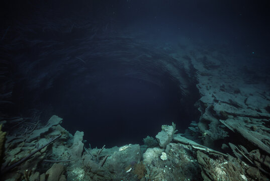 Generated fictional underwater scene with seabed and a large abyss pit.