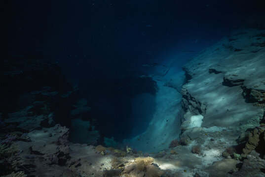 Generated fictional underwater scene with seabed and a large abyss pit.