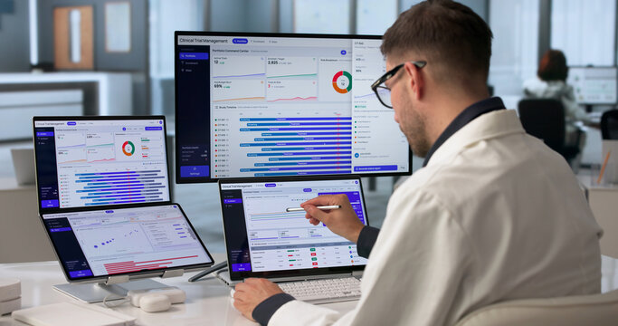 Young Clinical Trial Manager Reviewing Patient Enrollment Data