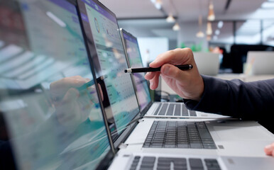 Obraz na płótnie Canvas Facility Manager Uses Laptop To Track