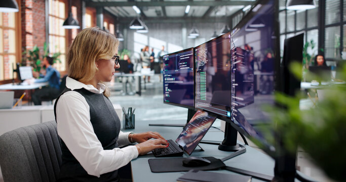 Young Woman Programs Code On Her Laptop