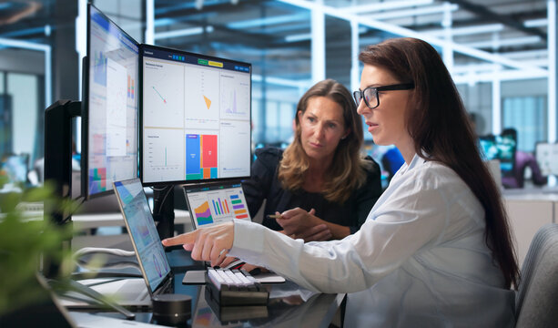 Group Of Financial Analysts Reviewing Market Data