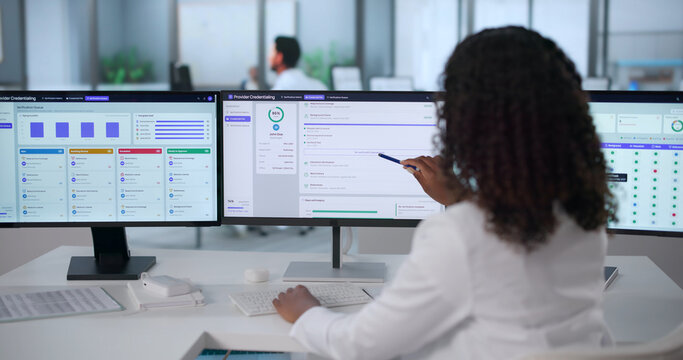 Female Doctor Uses Medical Software On Computer