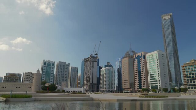 sunny day abu dhabi city center construction new park square pond panorama 4k united arab emirates