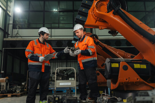 Robotic technicians specialists discusses robot assembly component in robot warehouse for assembly customer specifications. system integration.