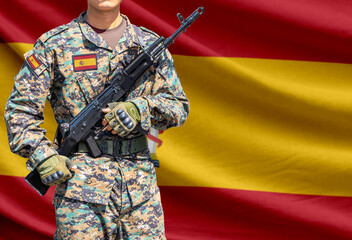 Fototapeta premium Spain flag with soldier holding assault rifle