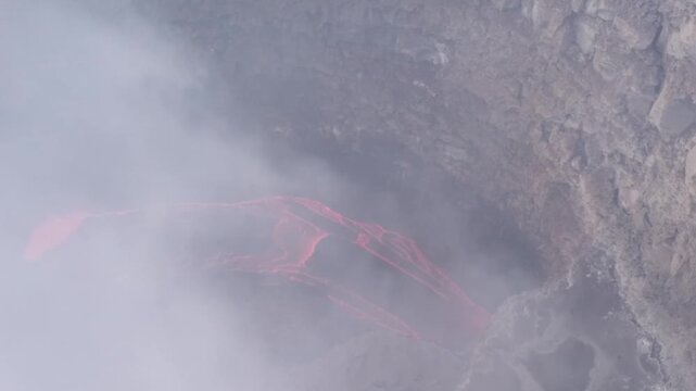 Erta Ale volcano, View of the glowing lava lake inside the crater, with molten rock patterns and dark volcanic rock walls in Zone 2, Afar, Ethiopia.