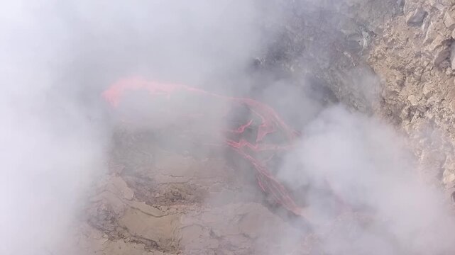 Erta Ale volcano, View of the glowing lava lake inside the crater, with molten rock patterns and dark volcanic rock walls in Zone 2, Afar, Ethiopia.