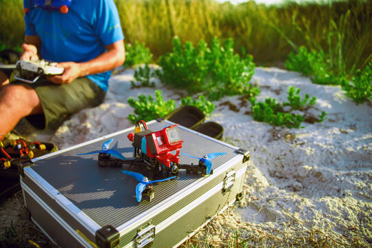 Modern hobby drone on warm beach sand