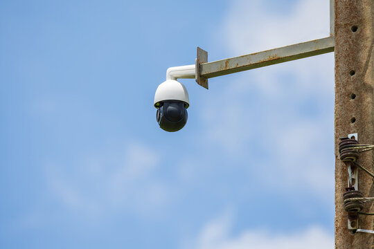 Security surveillance camera installed on utility pole for public safety and remote monitoring, outdoor CCTV system, clear blue sky with copy space, smart city infrastructure, , monitoring technology
