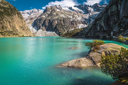 Picturesque turquoise Gelmersee lake and snowy mountains, Grimsel Pass, Switzerland