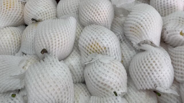 Fresh Pears in Protective Net Packaging Close Up