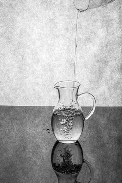 Pouring water into a glass decanter