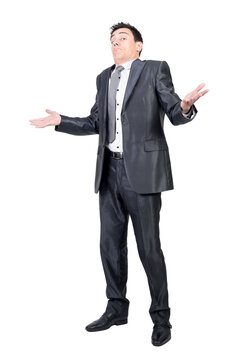 Confused male worker shrugging shoulders in studio