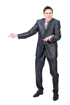 Surprised man in elegant suit pointing aside
