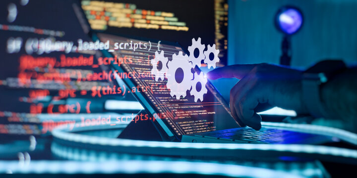 Developer interacting with virtual glowing gears and programming code on a futuristic laptop interface.