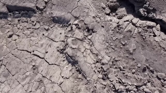 Erta Ale volcano, Aerial view of cracked and solidified lava crust of the Erta Ale volcano, showing deep fissures and jagged volcanic rock formations in Zone 2, Afar, Ethiopia.