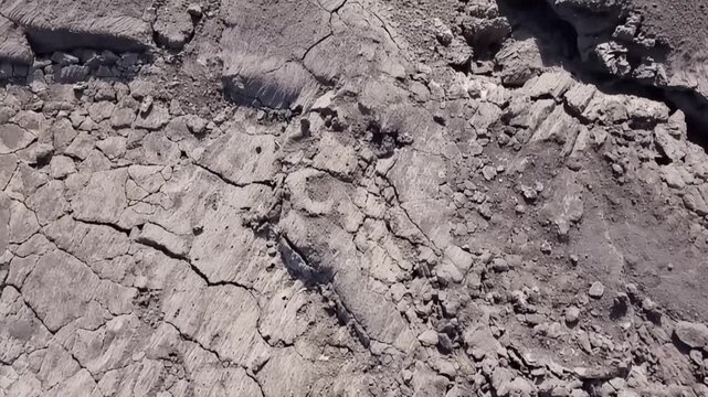 Erta Ale volcano, Aerial view of cracked and solidified lava crust of the Erta Ale volcano, showing deep fissures and jagged volcanic rock formations in Zone 2, Afar, Ethiopia.
