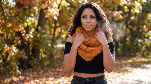 Woman Adjusting Warm Yellow Infinity Scarf in Outdoor Autumn Forest Path