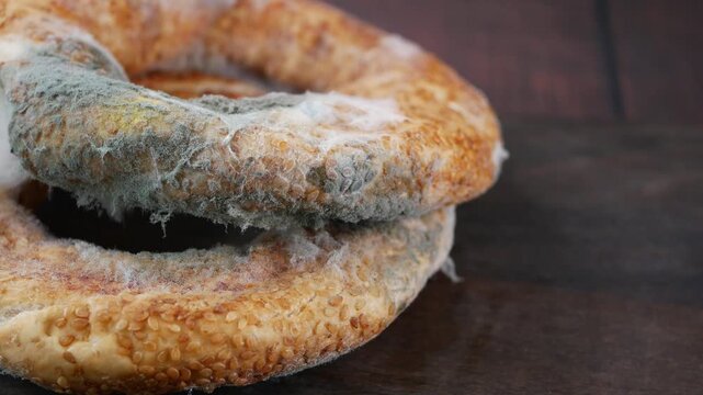 Old bread with mold on wooden surface