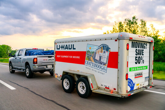 Buffalo, NY - Jun 25, 2026: Exterior sunset roadside view of a U‑Haul trailer traveling through I‑90 / NYS Thruway corridor