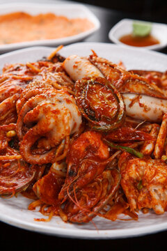 Close-up of Korean spicy monkfish stew agujjim served with tongs