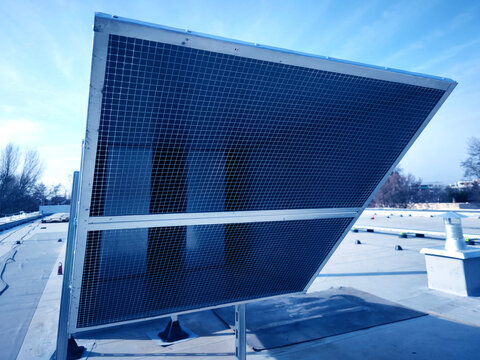 Detailed view of stainless steel vent cap on commercial building roof during maintenance check