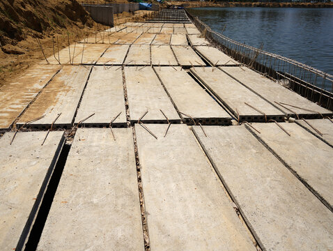 Building process city levee. Exposed foundation rebar grid at site, standing formwork and concrete footings