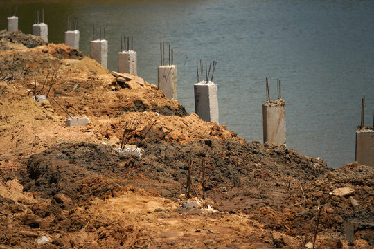 Building process city levee. Exposed foundation rebar grid at site, standing formwork and concrete footings