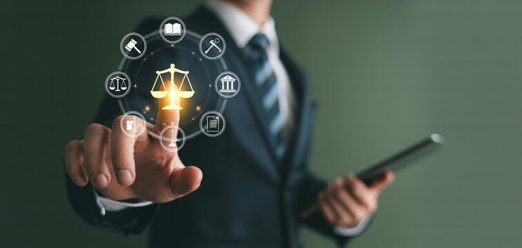 Businessman using tablet while selecting digital law and justice icons in legal consulting interface.