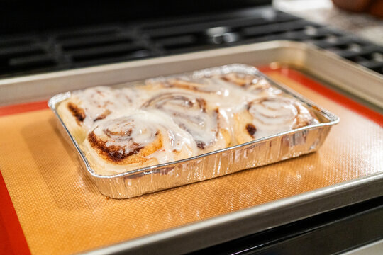 Freshly Baked Cinnamon Rolls Cooling on Stove Top