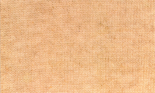 Light brown knitted fabric background macro texture, soft beige wool sweater textile pattern surface