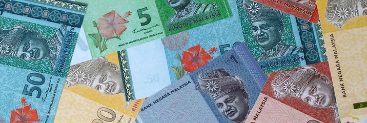 Malaysian ringgit money bills in pile on table. Malaysia MYR currency cash close up © Viktor