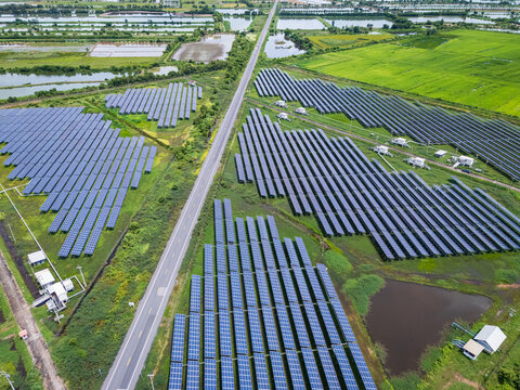 Aerial view drone shot scenic landscape of a road passing through a solar farm in Thailand