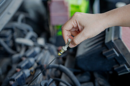 Mechanic Hand Checking Engine Oil Level