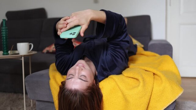 A young woman laughs at funny videos while endless smartphone scrolling keeps delivering quick dopamine rewards that quietly replace meaningful rest and real recovery