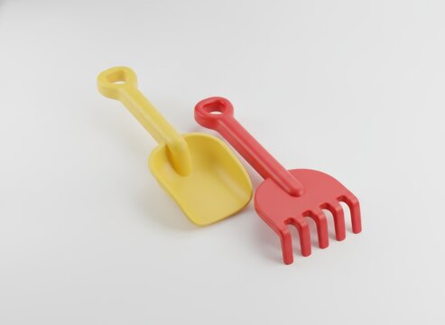 Yellow plastic shovel and red rake for sand play