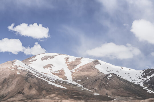 Rocky mountain slopes in the Pamir Mountains in Tajikistan, a minimalist landscape and rocky hills in sunny weather