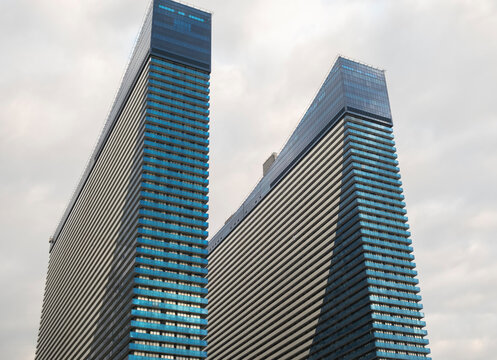 Modern high-rise buildings of the Orbi City Hotel, with their unique design, stand out in the urban environment during cloudy weather. August 24, 2025. Batumi, Georgia.